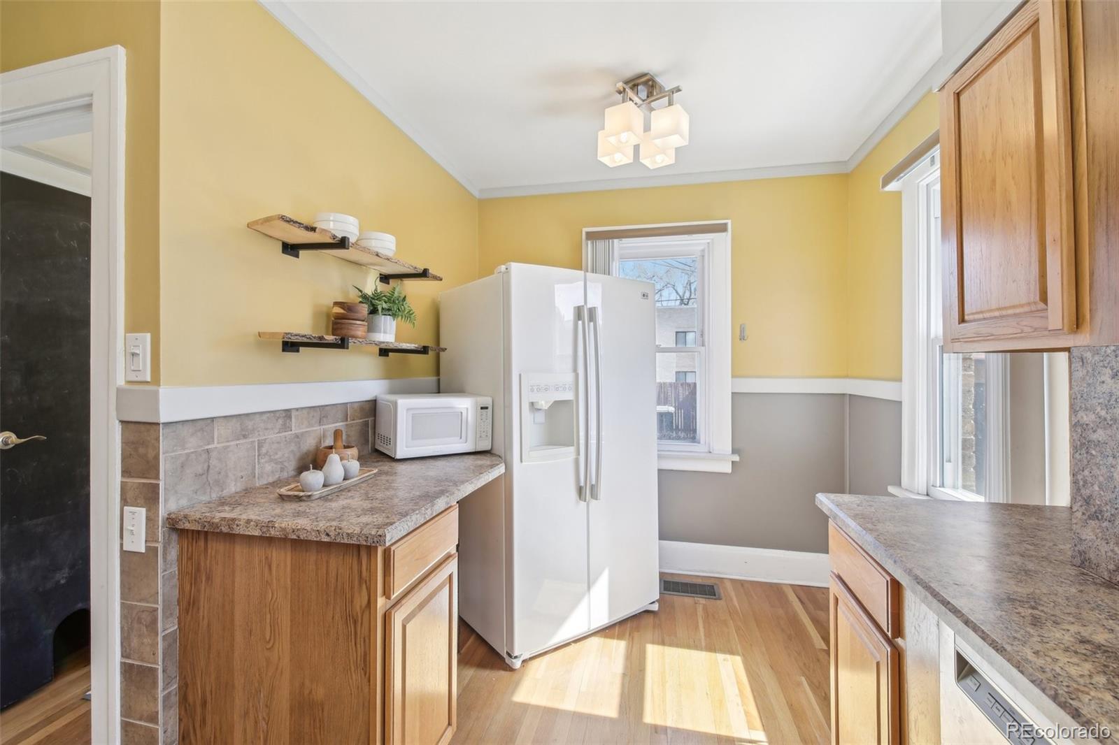 1462 Eudora Street Denver, CO 80220 - Photo 11 of 38 a bathroom with a granite countertop sink and a mirror