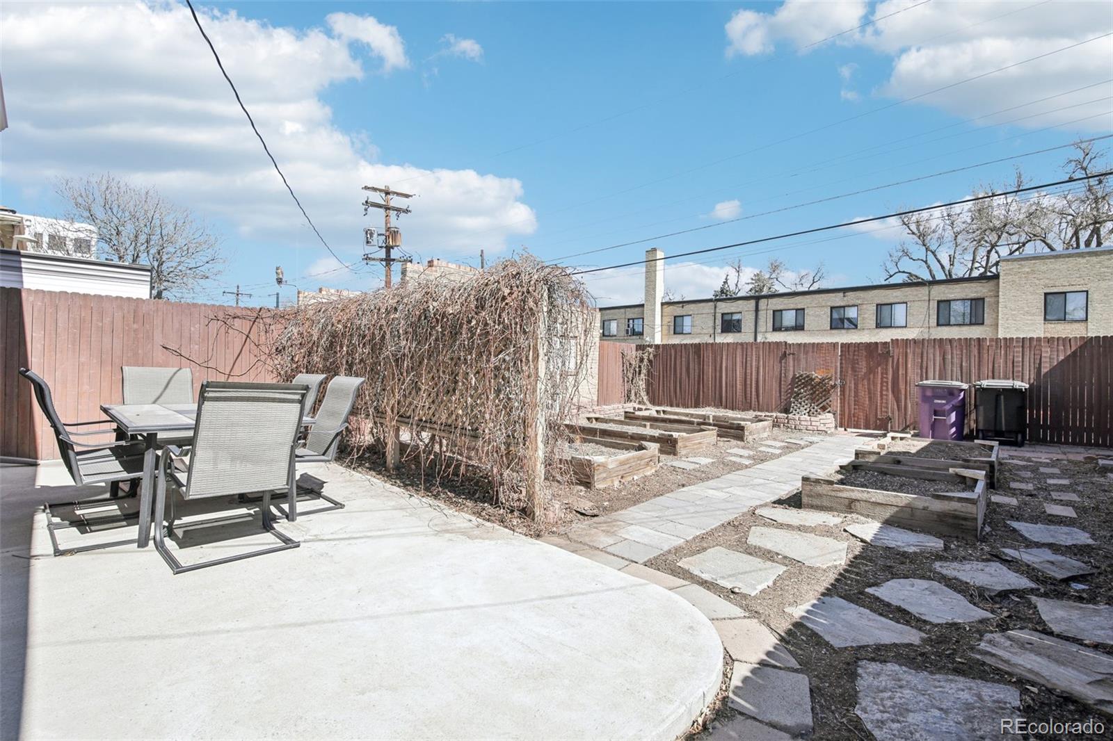 1462 Eudora Street Denver, CO 80220 - Photo 30 of 38 a view of a patio with a table and chairs