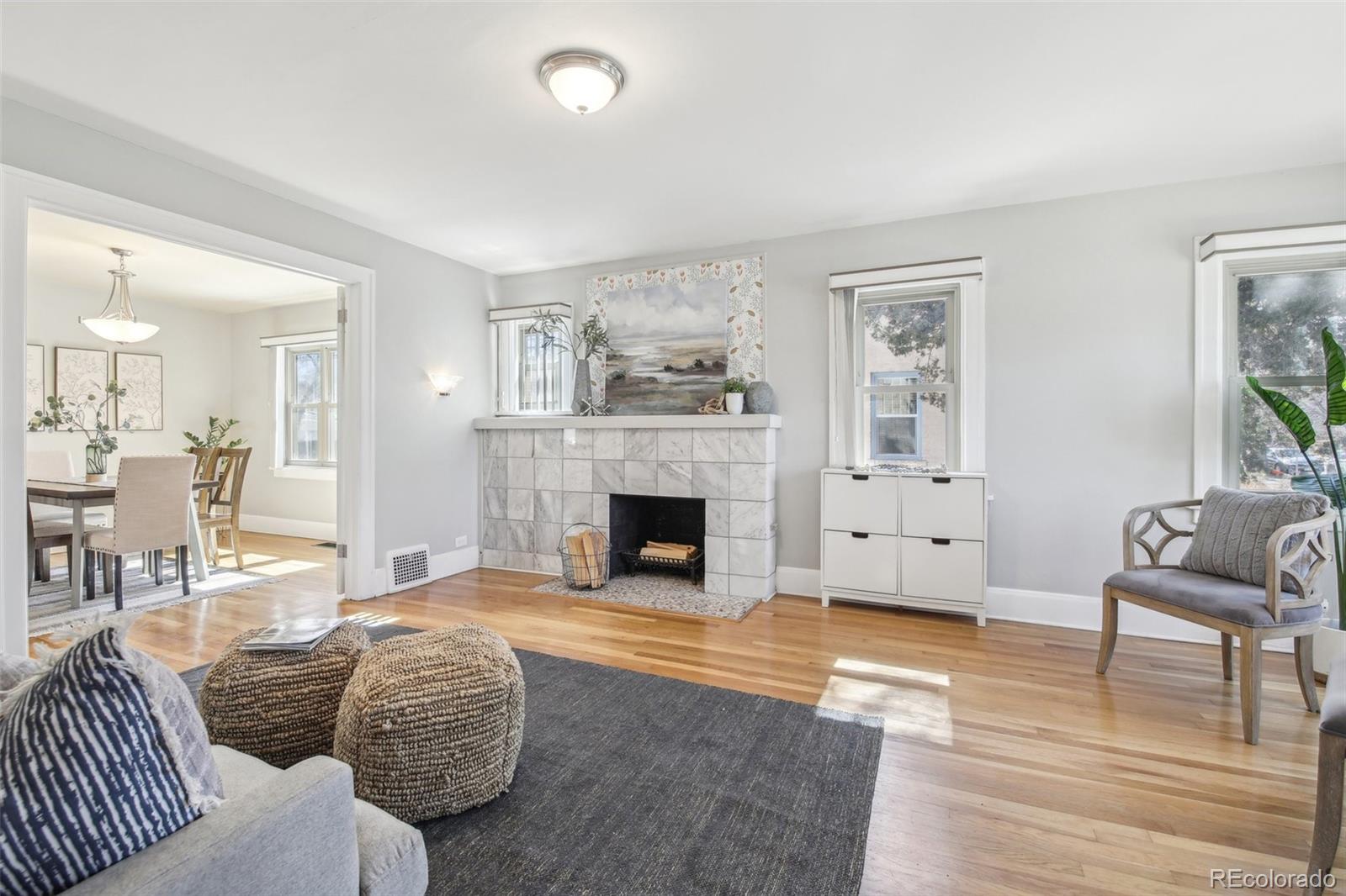 1462 Eudora Street Denver, CO 80220 - Photo 3 of 38 a living room with furniture and a fireplace