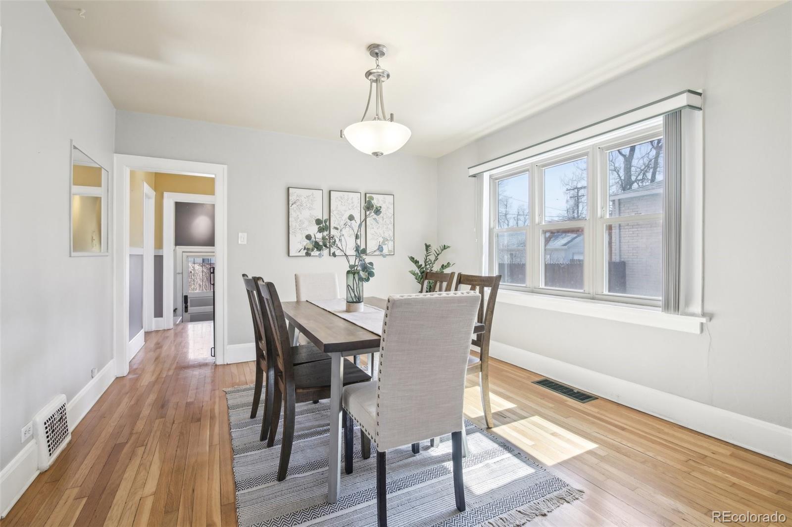 1462 Eudora Street Denver, CO 80220 - Photo 8 of 38 a view of a dining room with furniture wooden floor and a rug