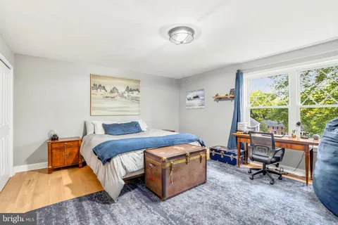 a bed room with a bed and a chair