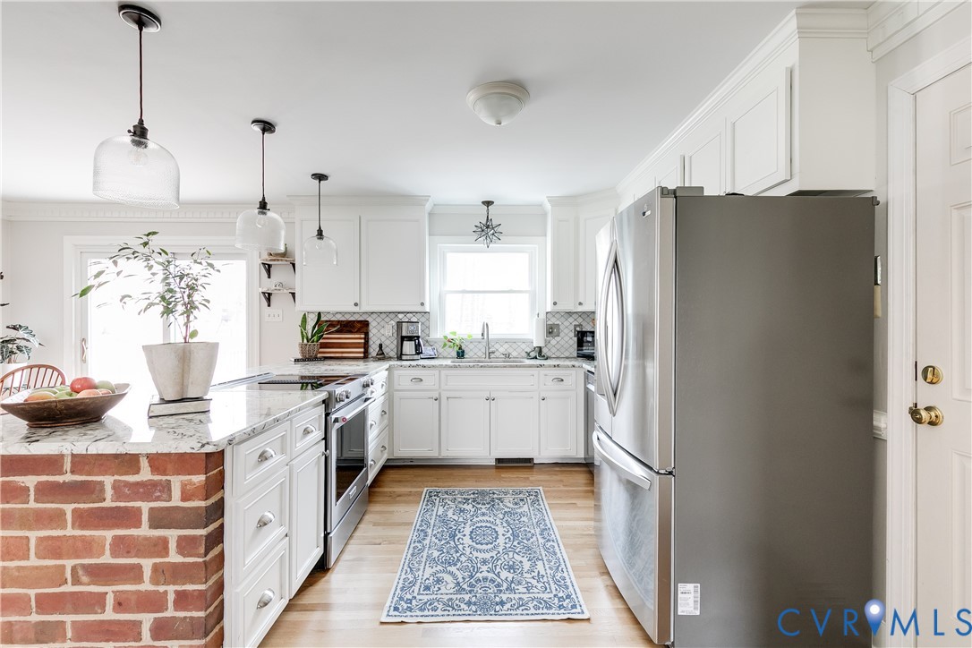 2021 Swamp Fox Road Midlothian, VA 23112 - Photo 19 of 73 a kitchen with a refrigerator and white cabinets