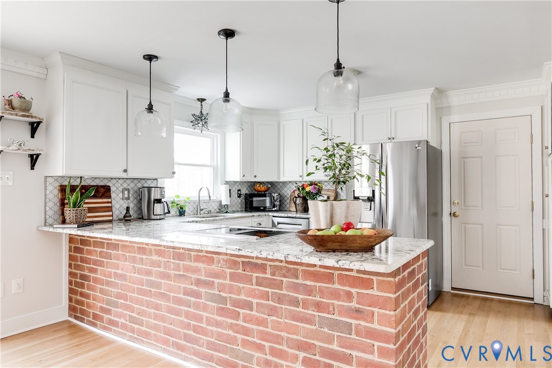 2021 Swamp Fox Road Midlothian, VA 23112 - Photo 23 of 73 a kitchen with kitchen island granite countertop a refrigerator a stove a sink and white cabinets