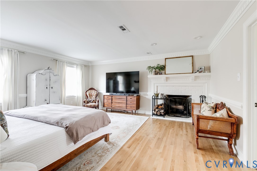 2021 Swamp Fox Road Midlothian, VA 23112 - Photo 34 of 73 a bedroom with a bed and a fireplace