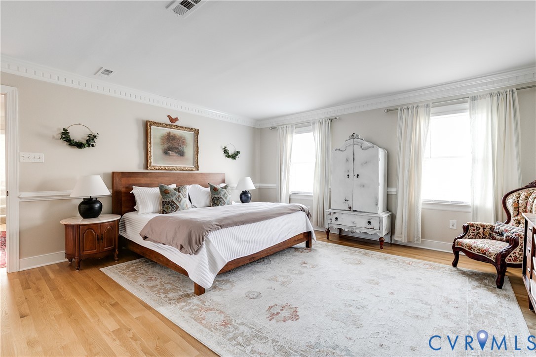 2021 Swamp Fox Road Midlothian, VA 23112 - Photo 36 of 73 a spacious bedroom with a bed a couch and a window