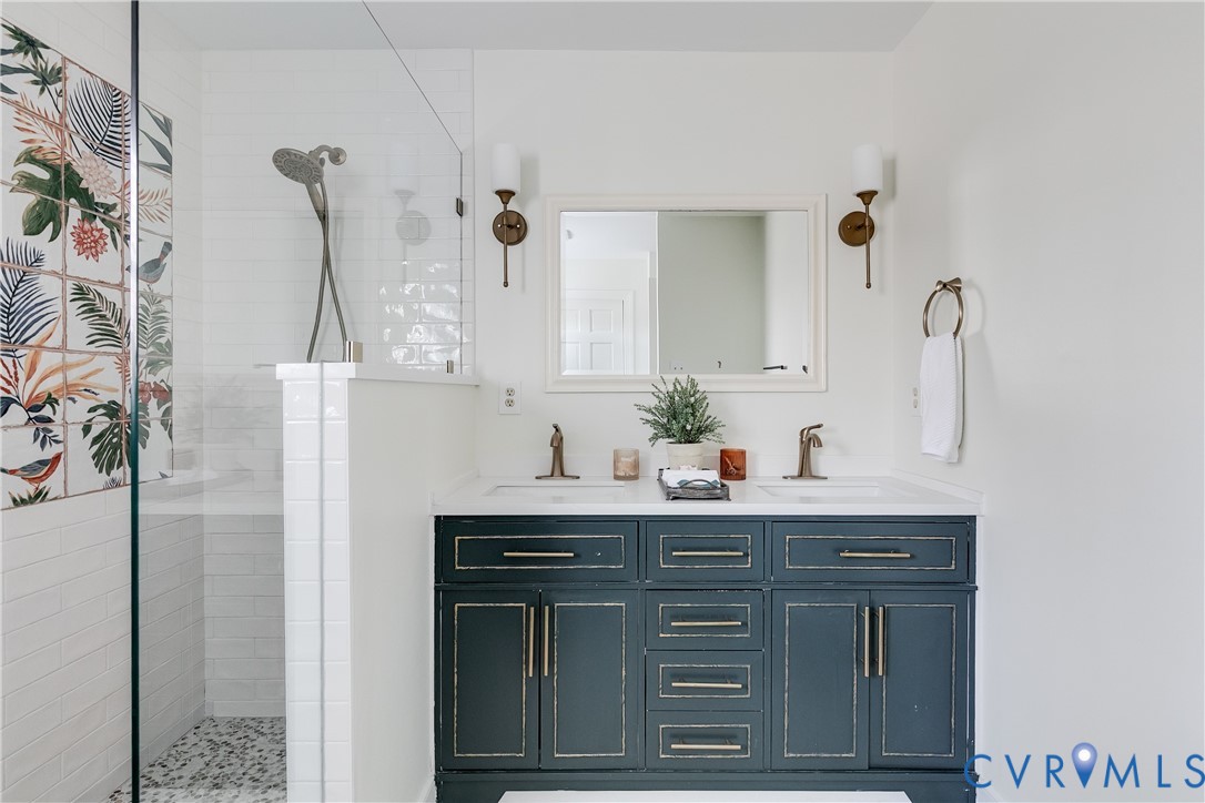 2021 Swamp Fox Road Midlothian, VA 23112 - Photo 44 of 73 a bathroom with a granite countertop shower a sink and a mirror