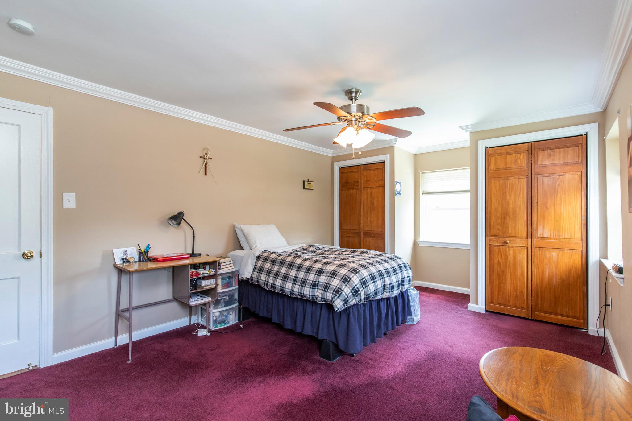 217 Alliston Road Springfield, PA 19064 - Photo 22 of 34 a spacious bedroom with a bed and a chandelier