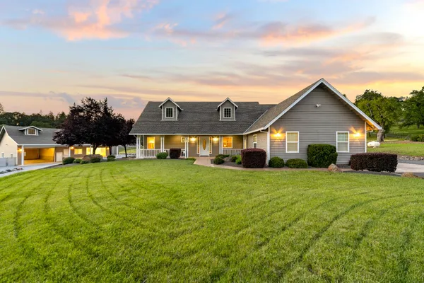 a front view of house with yard and green space