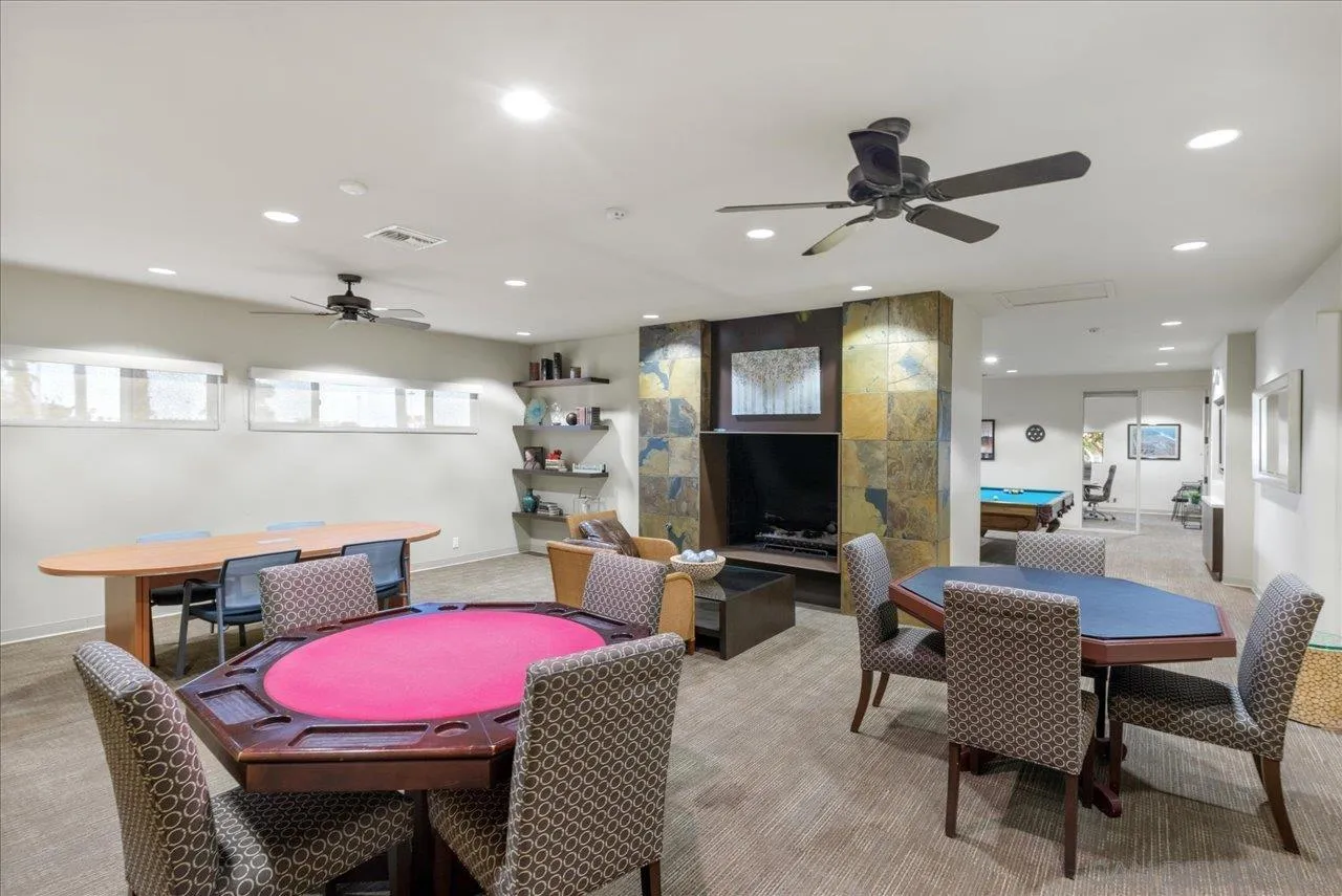 7144 Santa Rosa, Unit 86 Carlsbad, CA 92011 - Photo 18 of 30 a living room with furniture a flat screen tv and kitchen view