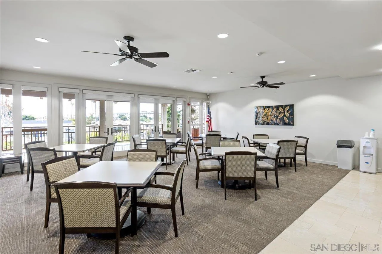 7144 Santa Rosa, Unit 86 Carlsbad, CA 92011 - Photo 20 of 30 a dining room with furniture a rug and a large window