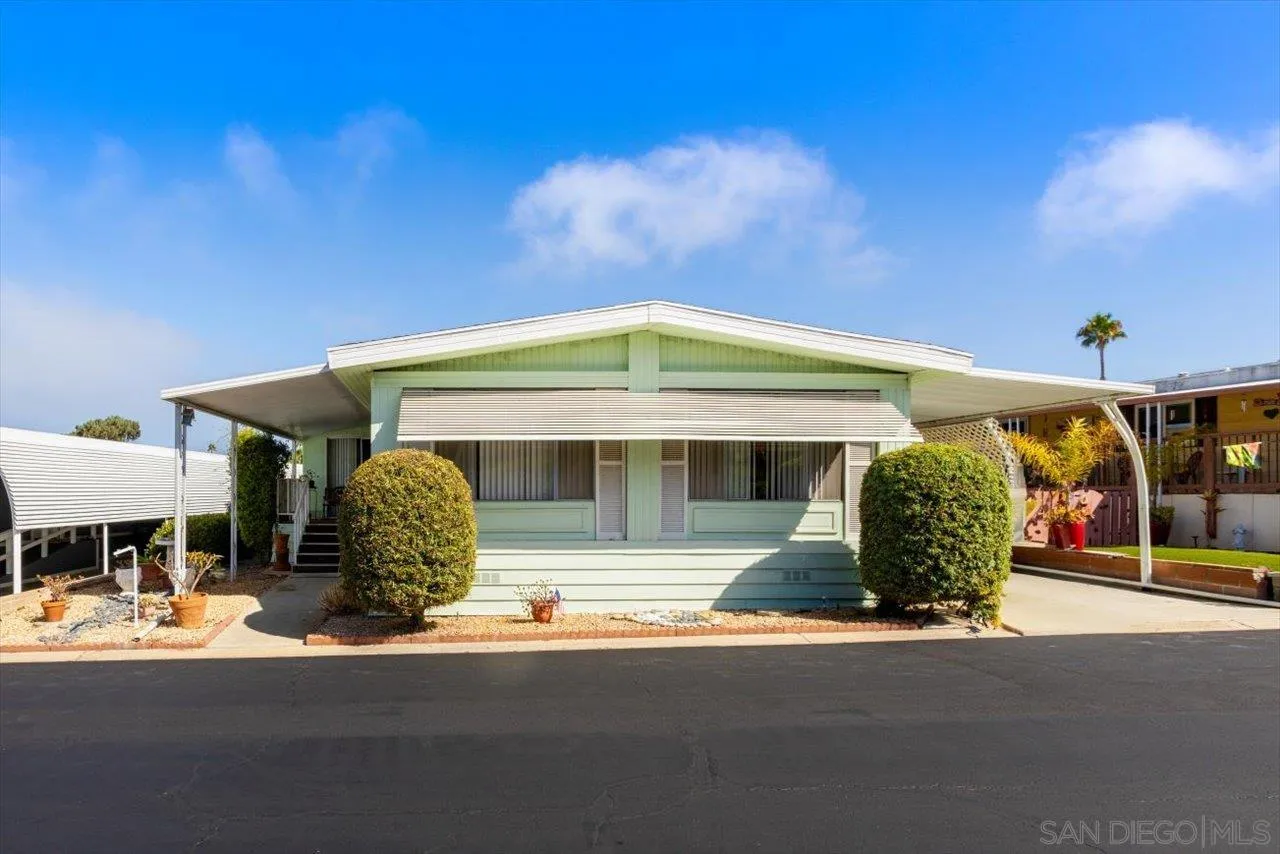 7144 Santa Rosa, Unit 86 Carlsbad, CA 92011 - Photo 2 of 30 a front view of a house with garden