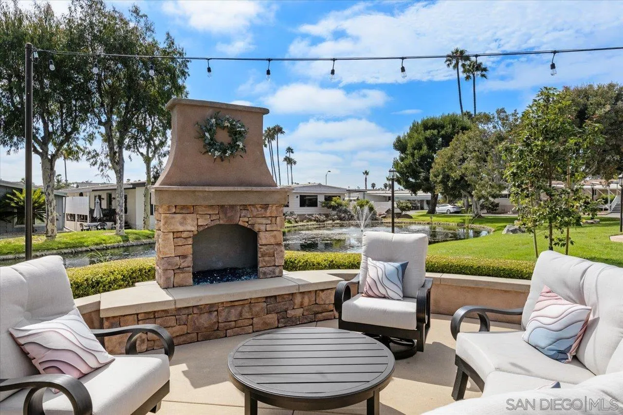 7144 Santa Rosa, Unit 86 Carlsbad, CA 92011 - Photo 23 of 30 a view of a patio with couches table and chairs