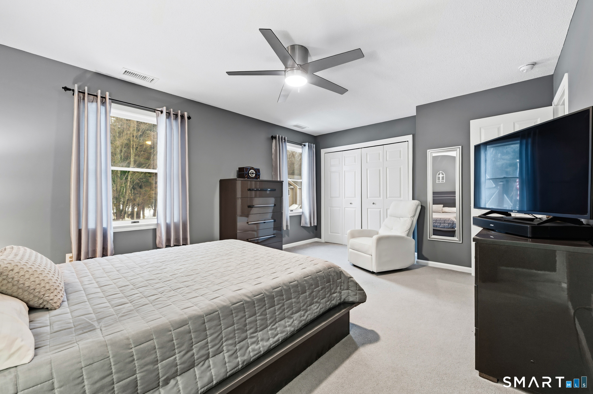 536 Redstone Hill Road, Unit 24 Bristol, CT 06010 - Photo 11 of 27 a bedroom with a large bed and a flat screen tv