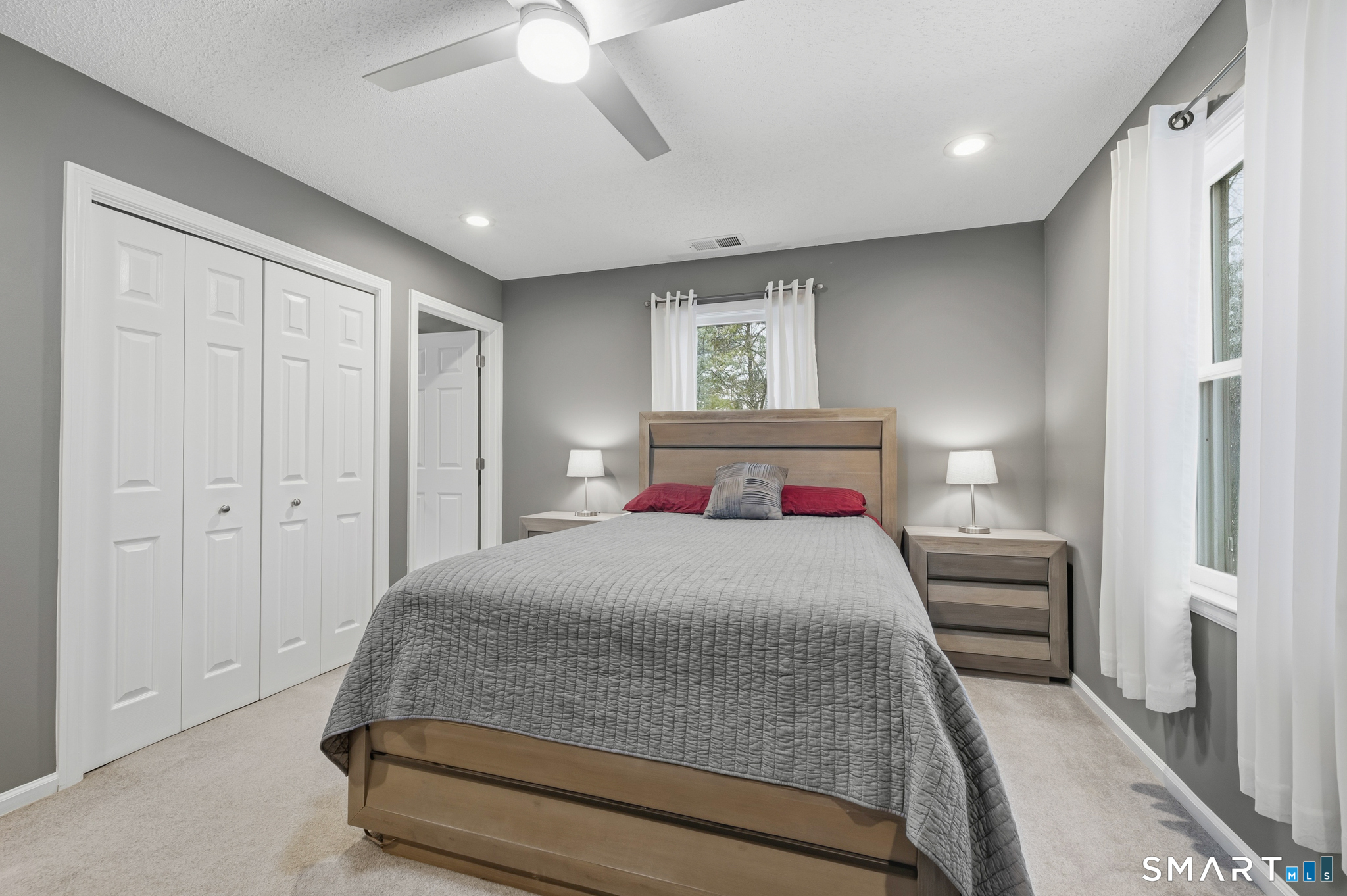 536 Redstone Hill Road, Unit 24 Bristol, CT 06010 - Photo 13 of 27 a bedroom with a large bed and a chandelier