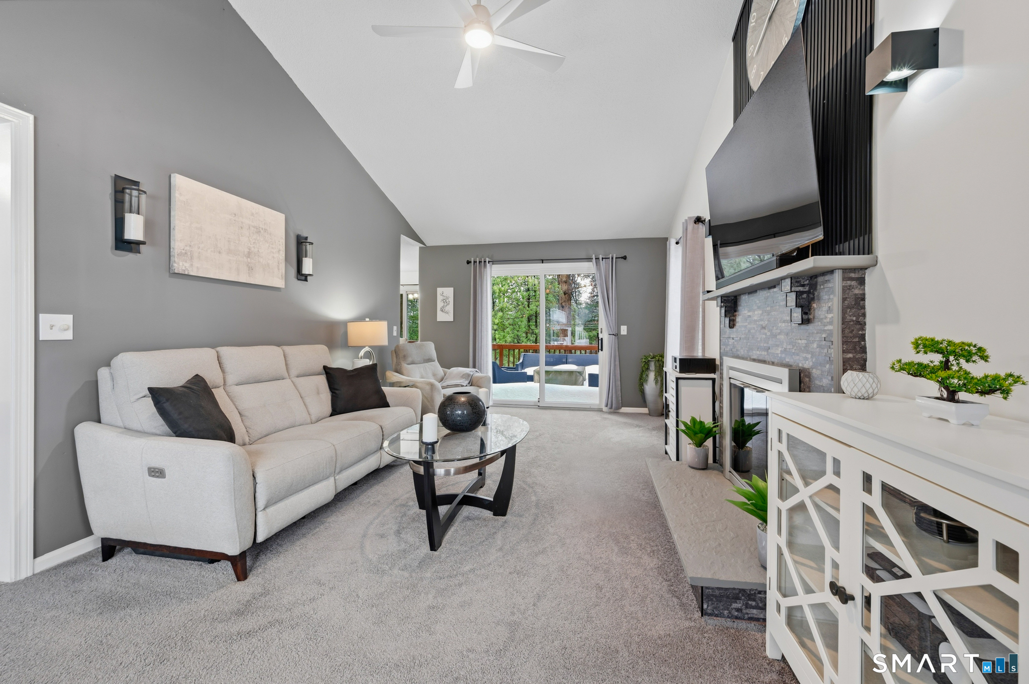 536 Redstone Hill Road, Unit 24 Bristol, CT 06010 - Photo 2 of 27 a living room with furniture and a flat screen tv