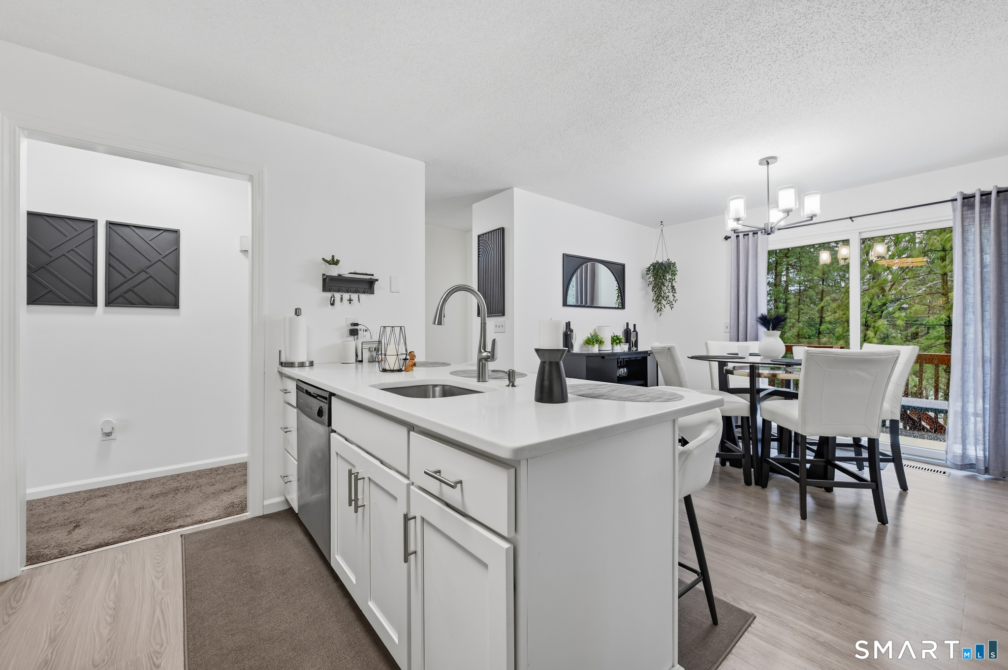 536 Redstone Hill Road, Unit 24 Bristol, CT 06010 - Photo 23 of 27 a open kitchen with stainless steel appliances granite countertop a stove and a view of dining room
