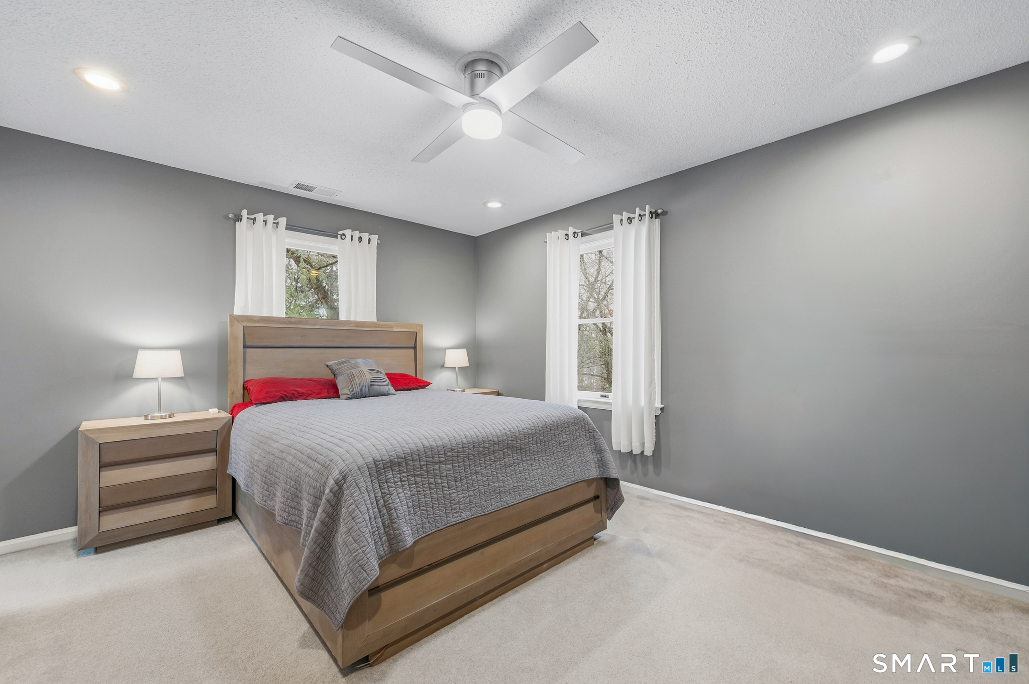 536 Redstone Hill Road, Unit 24 Bristol, CT 06010 - Photo 27 of 27 a bedroom with a bed and a ceiling fan
