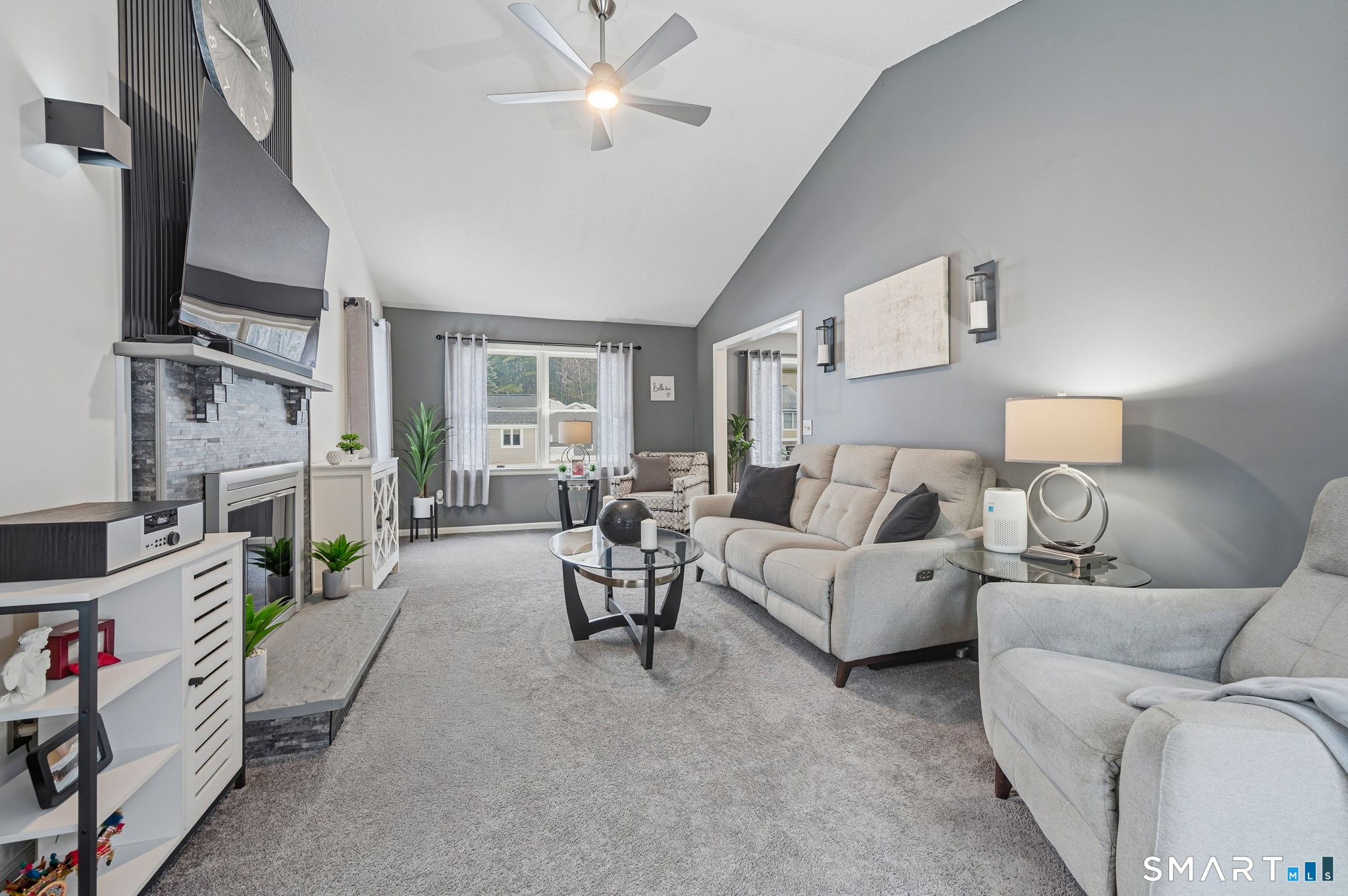 536 Redstone Hill Road, Unit 24 Bristol, CT 06010 - Photo 3 of 27 a living room with furniture and a flat screen tv