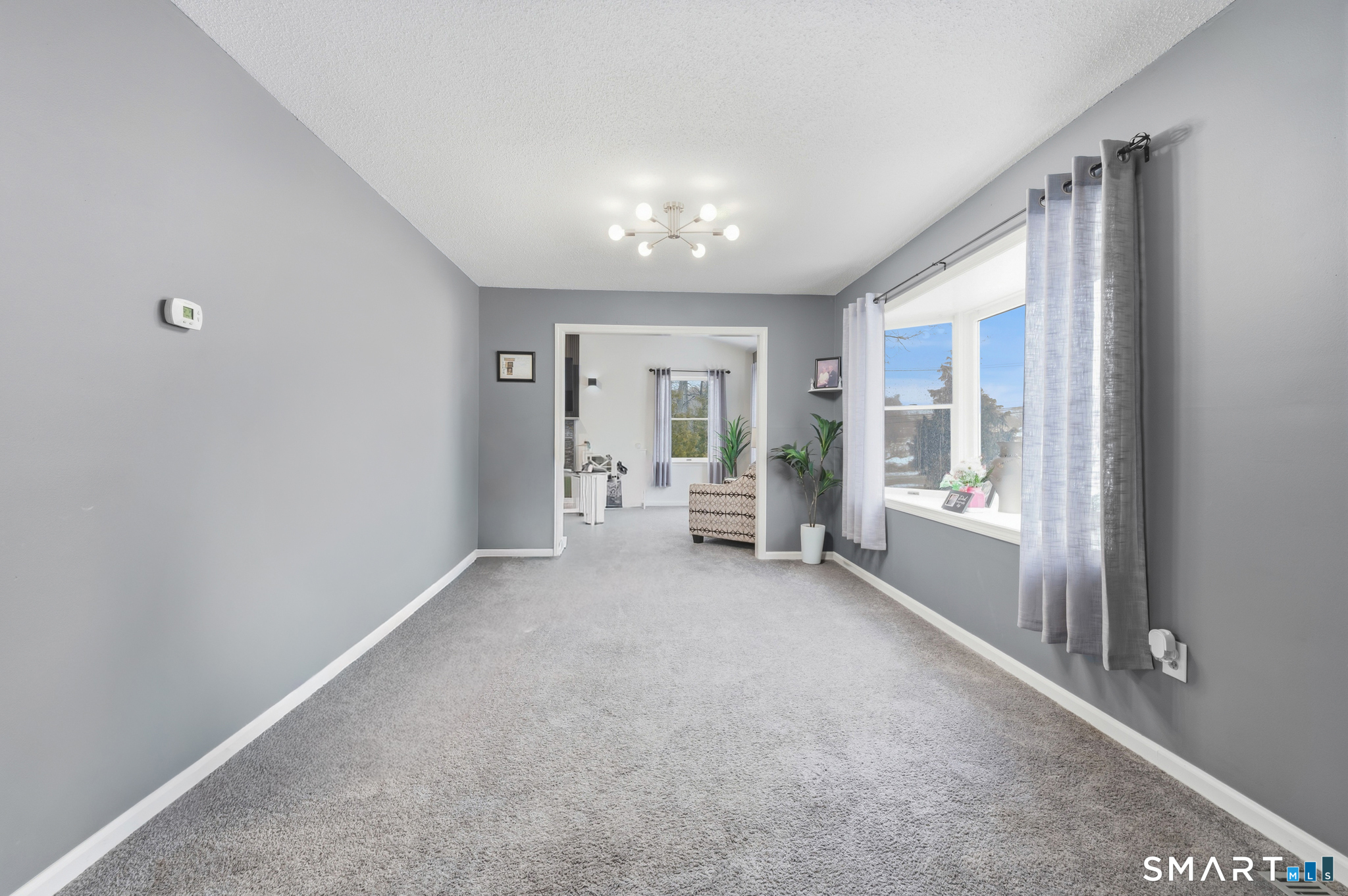 536 Redstone Hill Road, Unit 24 Bristol, CT 06010 - Photo 7 of 27 a view of a big room with large windows and furniture