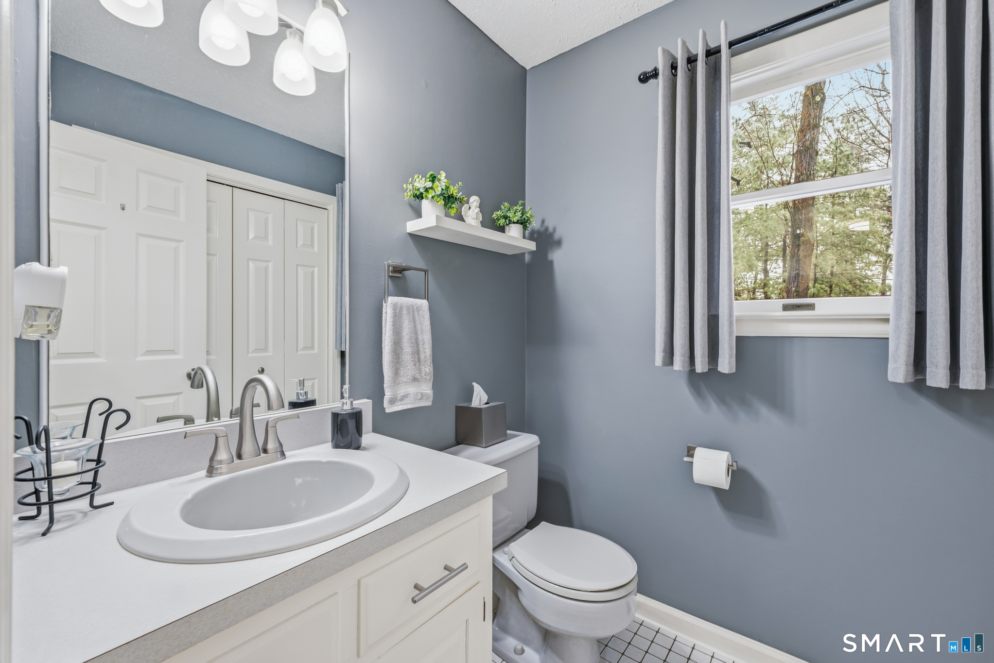 536 Redstone Hill Road, Unit 24 Bristol, CT 06010 - Photo 8 of 27 a bathroom with a toilet sink and mirror