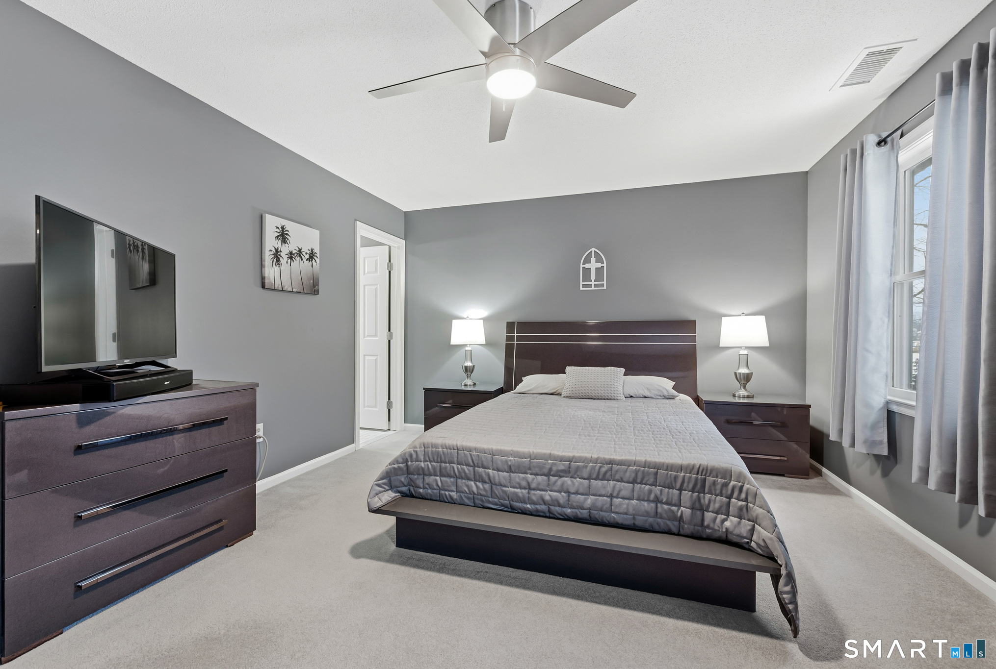 536 Redstone Hill Road, Unit 24 Bristol, CT 06010 - Photo 10 of 27 a bedroom with a bed and a flat screen tv