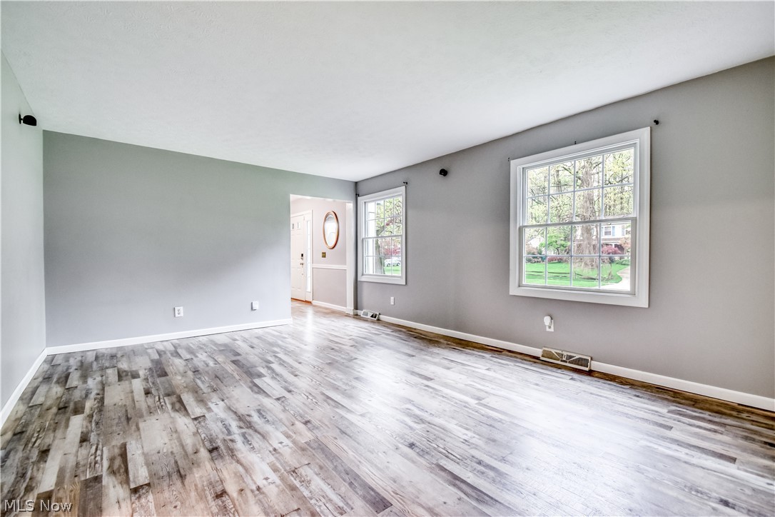 8242 Starburst Road Mentor, OH 44060 - Photo 30 of 37 Spacious room featuring wood-finish flooring, light gray walls, and white trim
