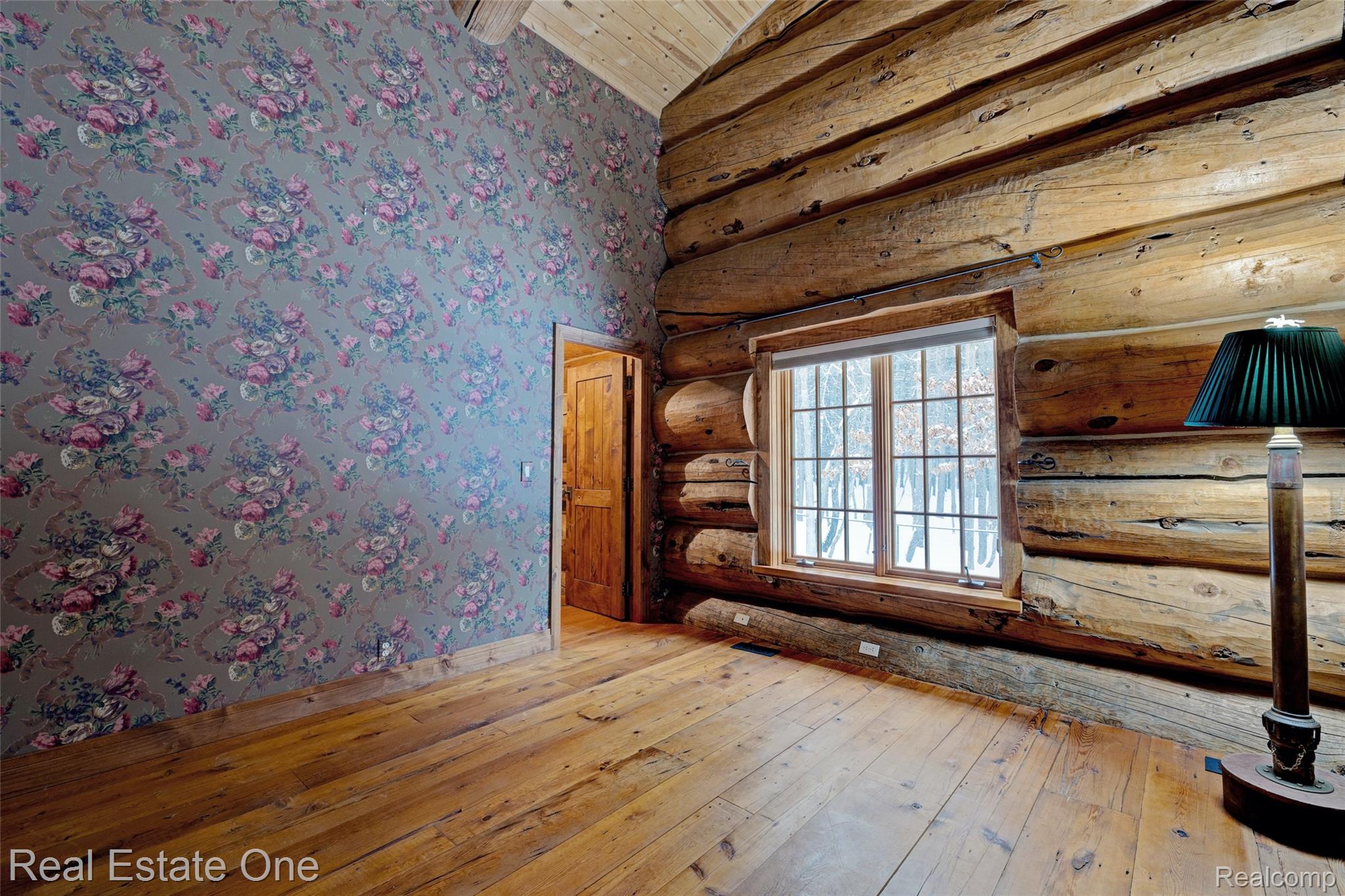 4340 Lahring Road Holly, MI 48442 - Photo 32 of 89 Unfurnished room featuring hardwood / wood-style floors, rustic walls, wallpapered walls, lofted ceiling, and wood ceiling