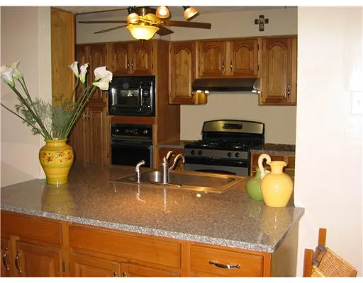 a bathroom with a granite countertop sink a vanity and a window