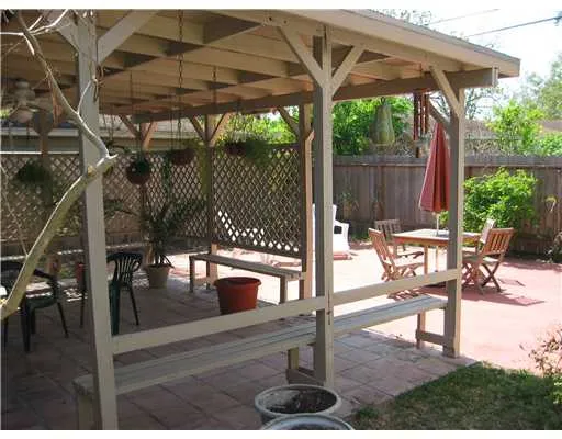 a building outdoor space with patio furniture and potted plants