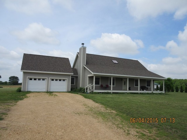 539 Morgan Road Amboy, IL 61310 - Photo 1 of 12 a front view of a house with a garden