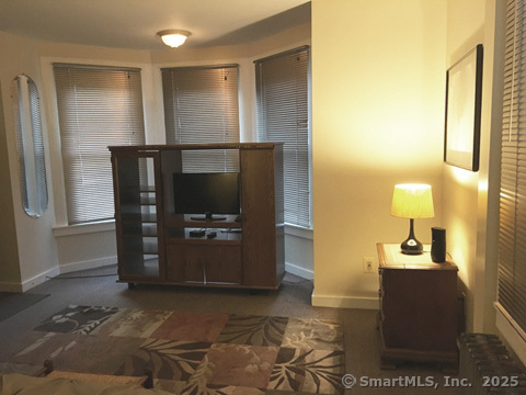 223 Broad Street Meriden, CT 06450 - Photo 11 of 17 a living room with a couch and a table