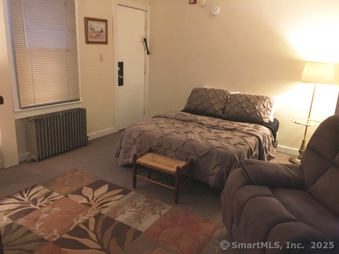 223 Broad Street Meriden, CT 06450 - Photo 12 of 17 a bedroom with a bed and a couch