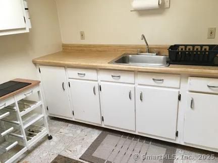 a kitchen with a sink and cabinets