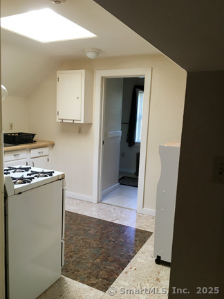 223 Broad Street Meriden, CT 06450 - Photo 6 of 17 a view of a kitchen with refrigerator and white cabinets