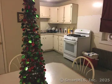 a kitchen with a white stove top oven and sink