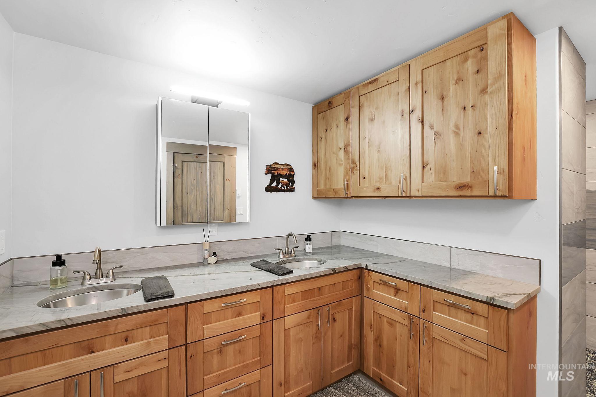 715 Spruce Street McCall, ID 83638 - Photo 27 of 37 Kitchen with light stone countertops and a sink