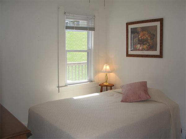 24 Baycrest Road Ipswich, MA 01938 - Photo 16 of 30 a bedroom with a bed and a lamp on table