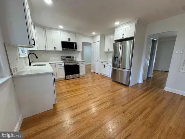 a kitchen with stainless steel appliances a refrigerator sink and microwave