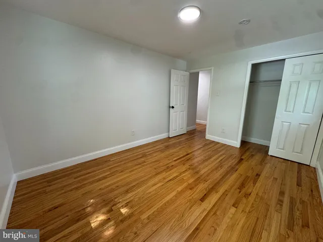 a view of an empty room and wooden floor