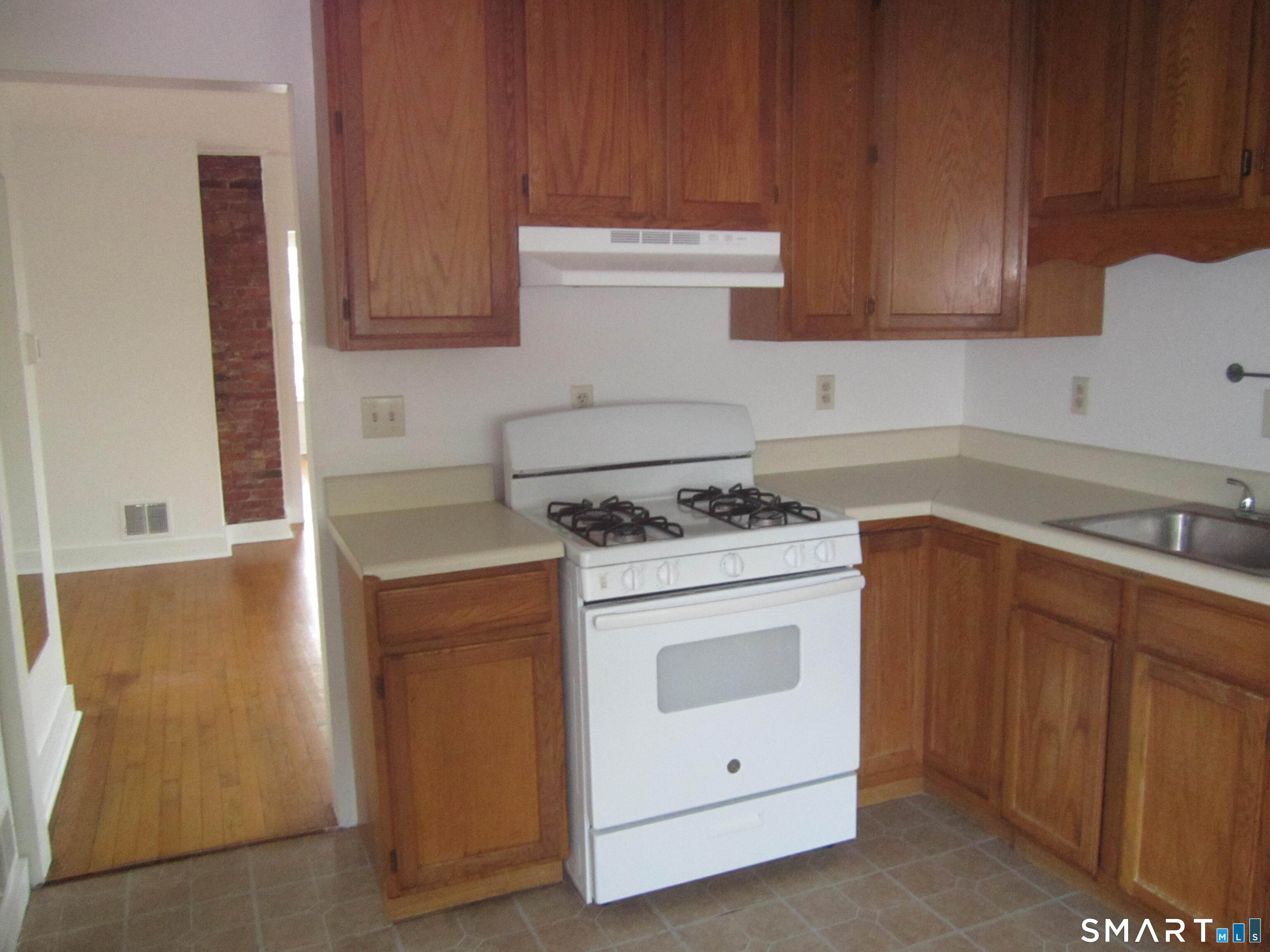 78 Alcove Street Meriden, CT 06451 - Photo 2 of 10 a kitchen with cabinets appliances and wooden floor