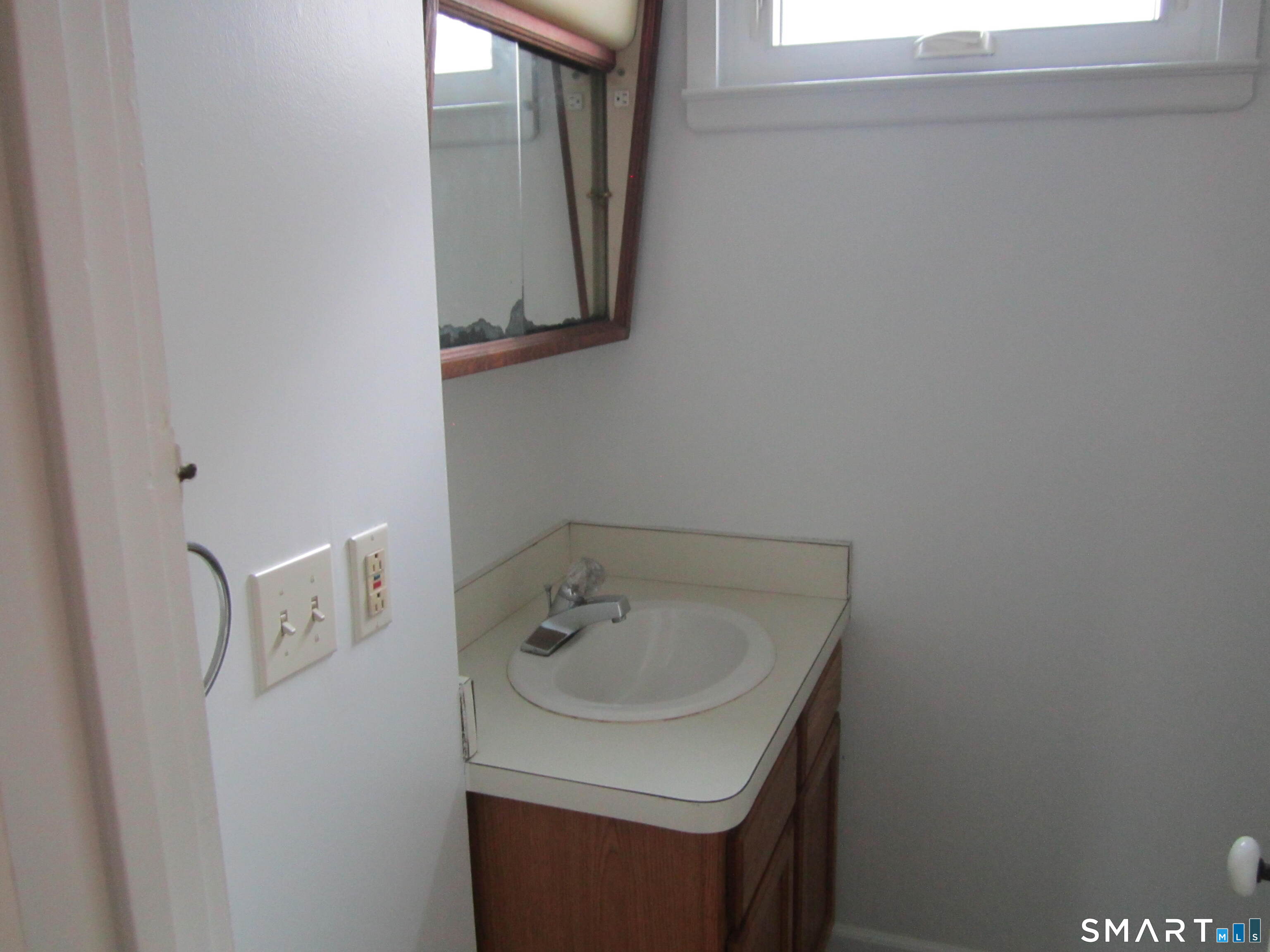 78 Alcove Street Meriden, CT 06451 - Photo 3 of 10 a bathroom with a sink and a mirror