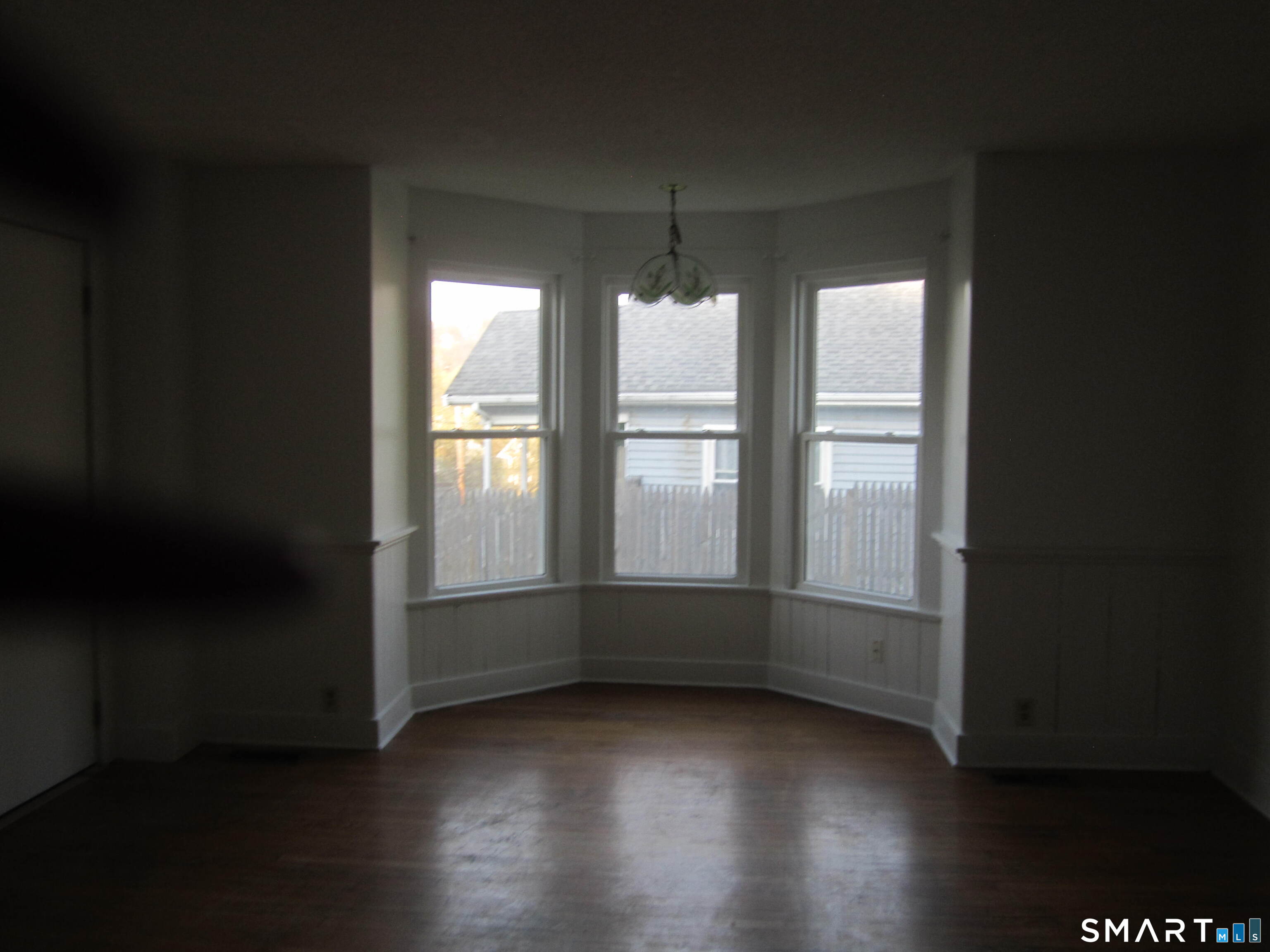 78 Alcove Street Meriden, CT 06451 - Photo 5 of 10 an empty room with wooden floor and windows