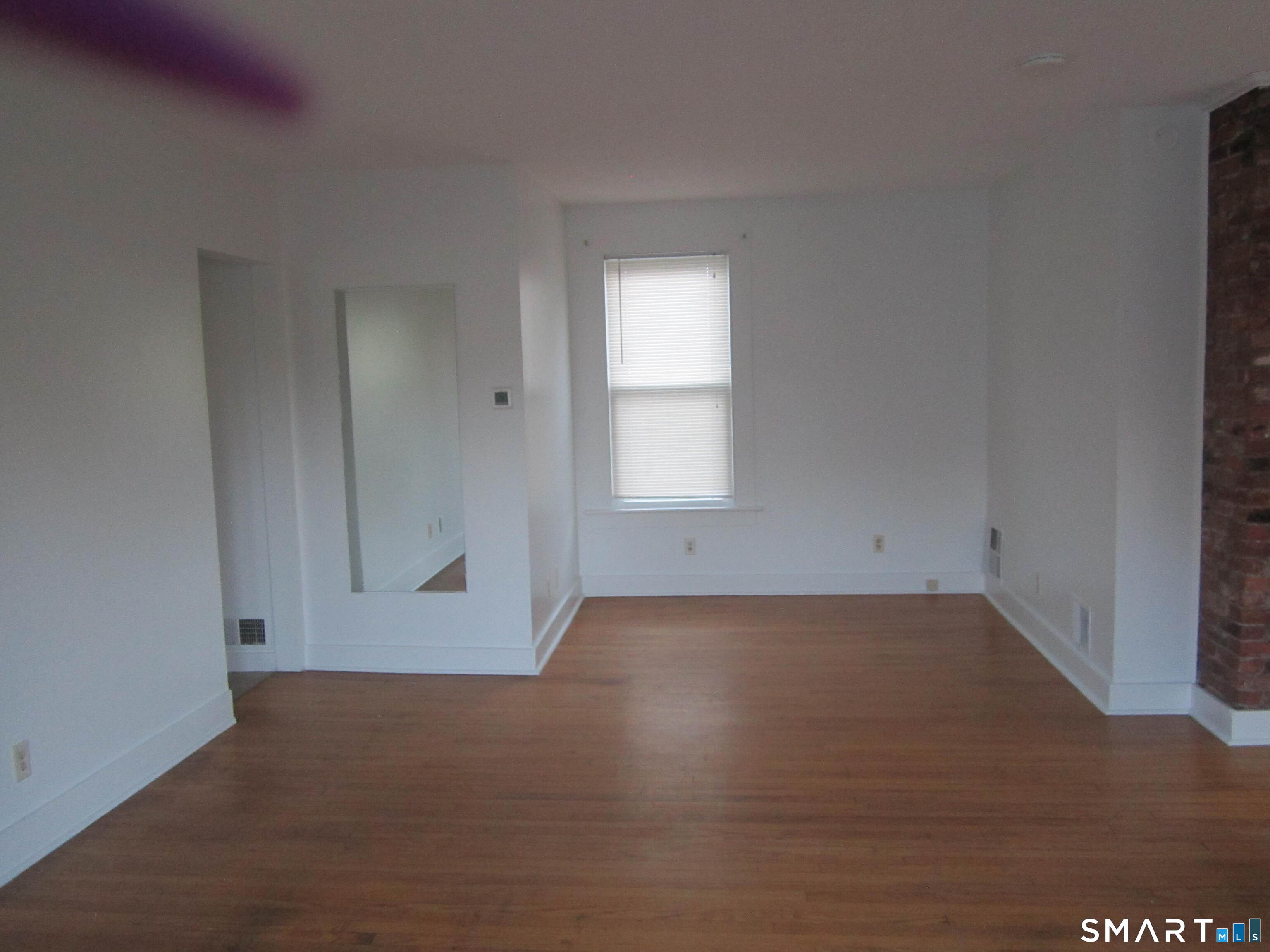 78 Alcove Street Meriden, CT 06451 - Photo 6 of 10 an empty room with wooden floor and windows