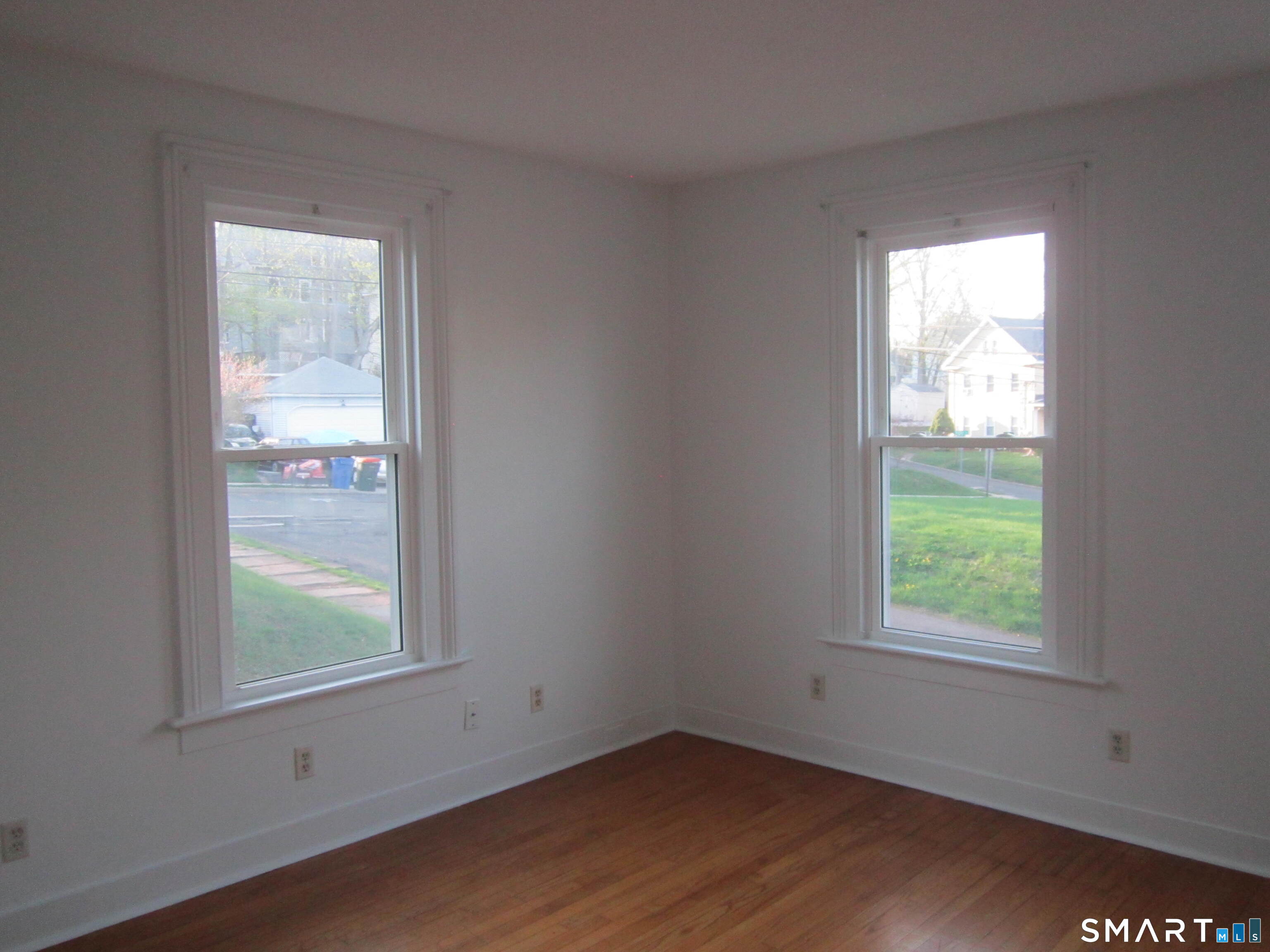 78 Alcove Street Meriden, CT 06451 - Photo 8 of 10 a view of an empty room with wooden floor and a window