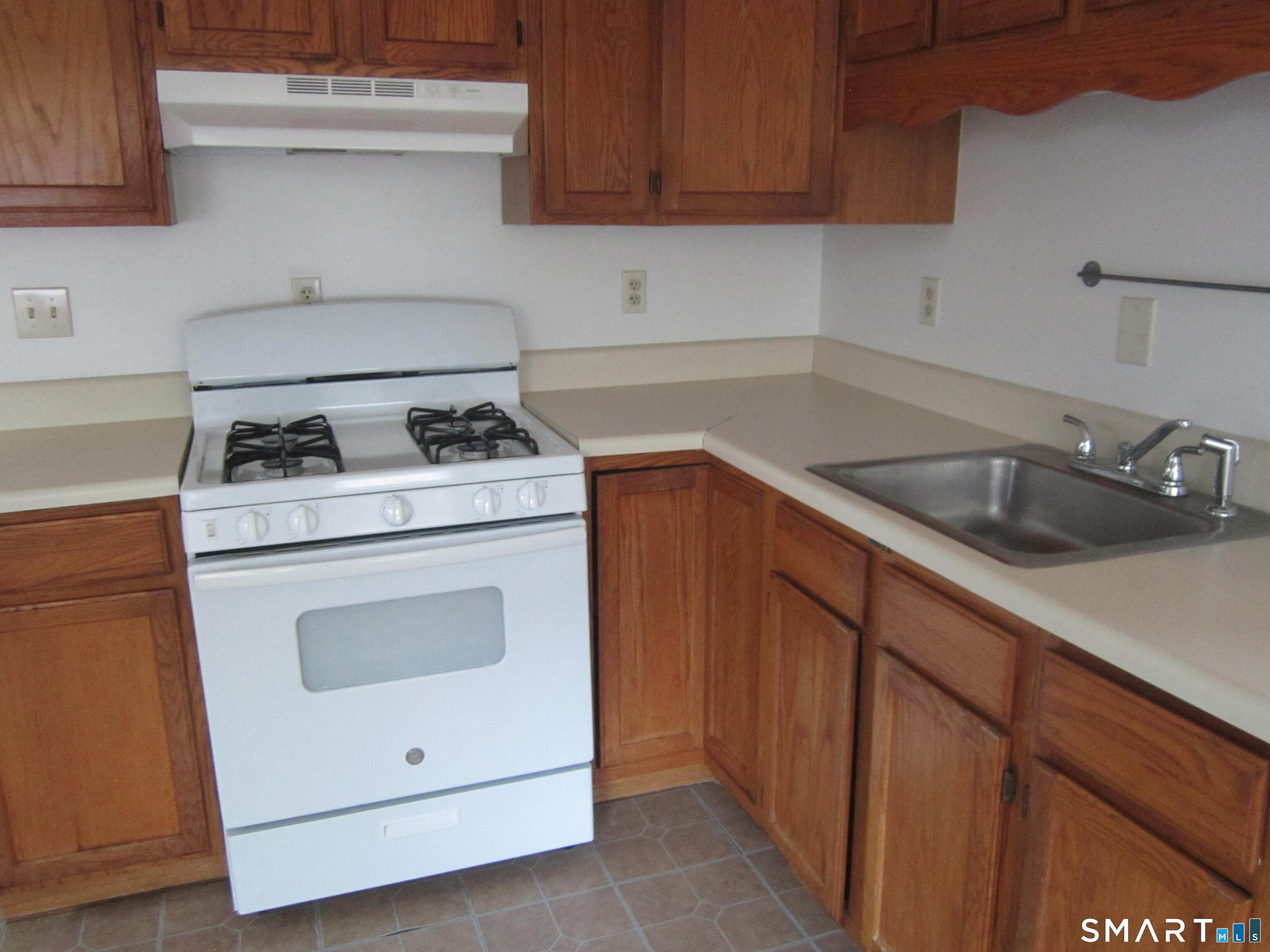 78 Alcove Street Meriden, CT 06451 - Photo 10 of 10 a kitchen with a stove sink and cabinets