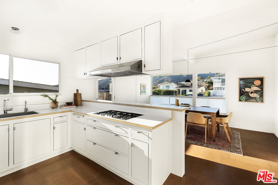 3702 Oceanhill Way Malibu, CA 90265 - Photo 7 of 8 a kitchen with cabinets and chairs