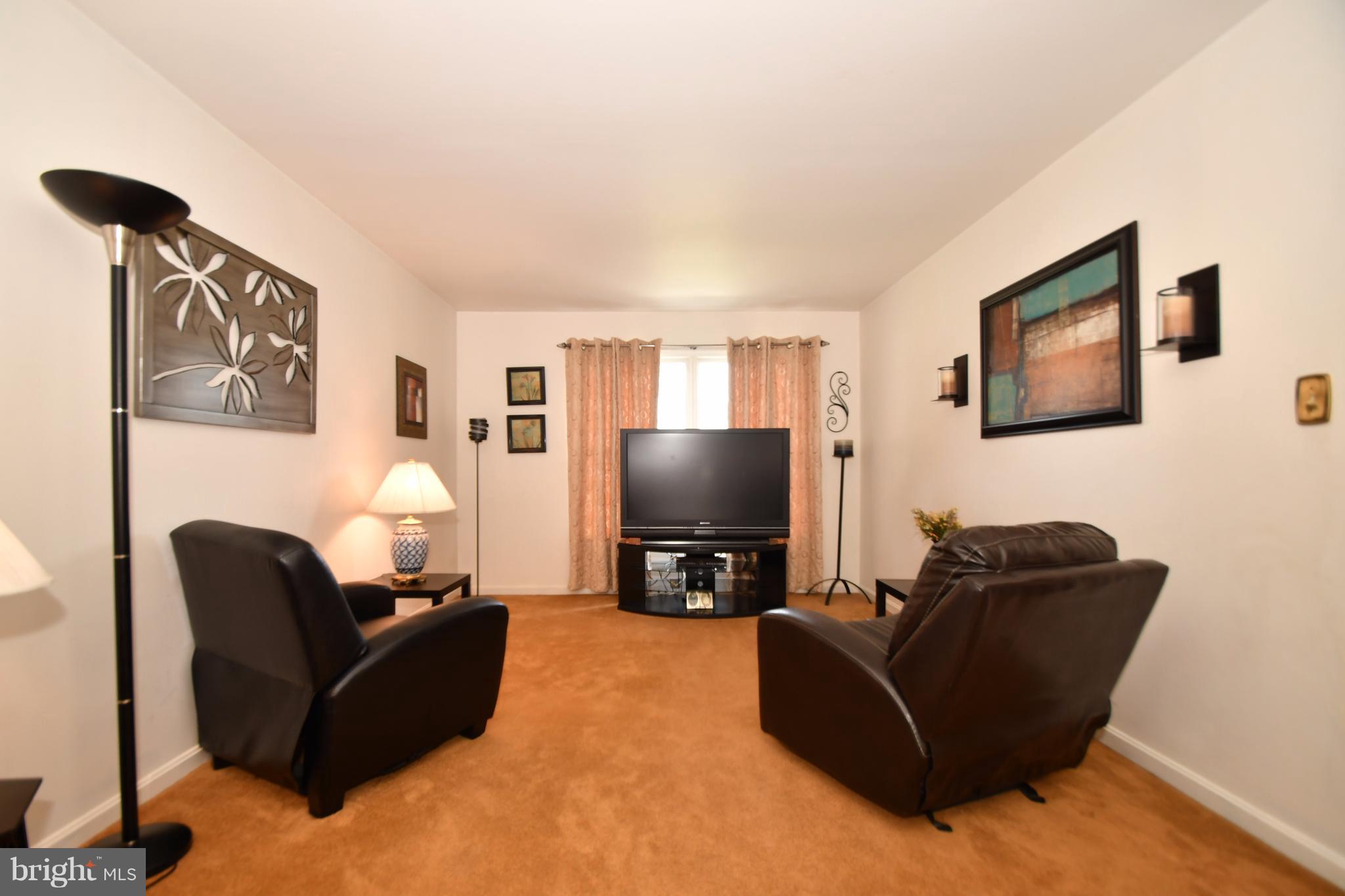 8126 Old Philadelphia Road Baltimore, MD 21237 - Photo 11 of 30 a living room with furniture and a flat screen tv