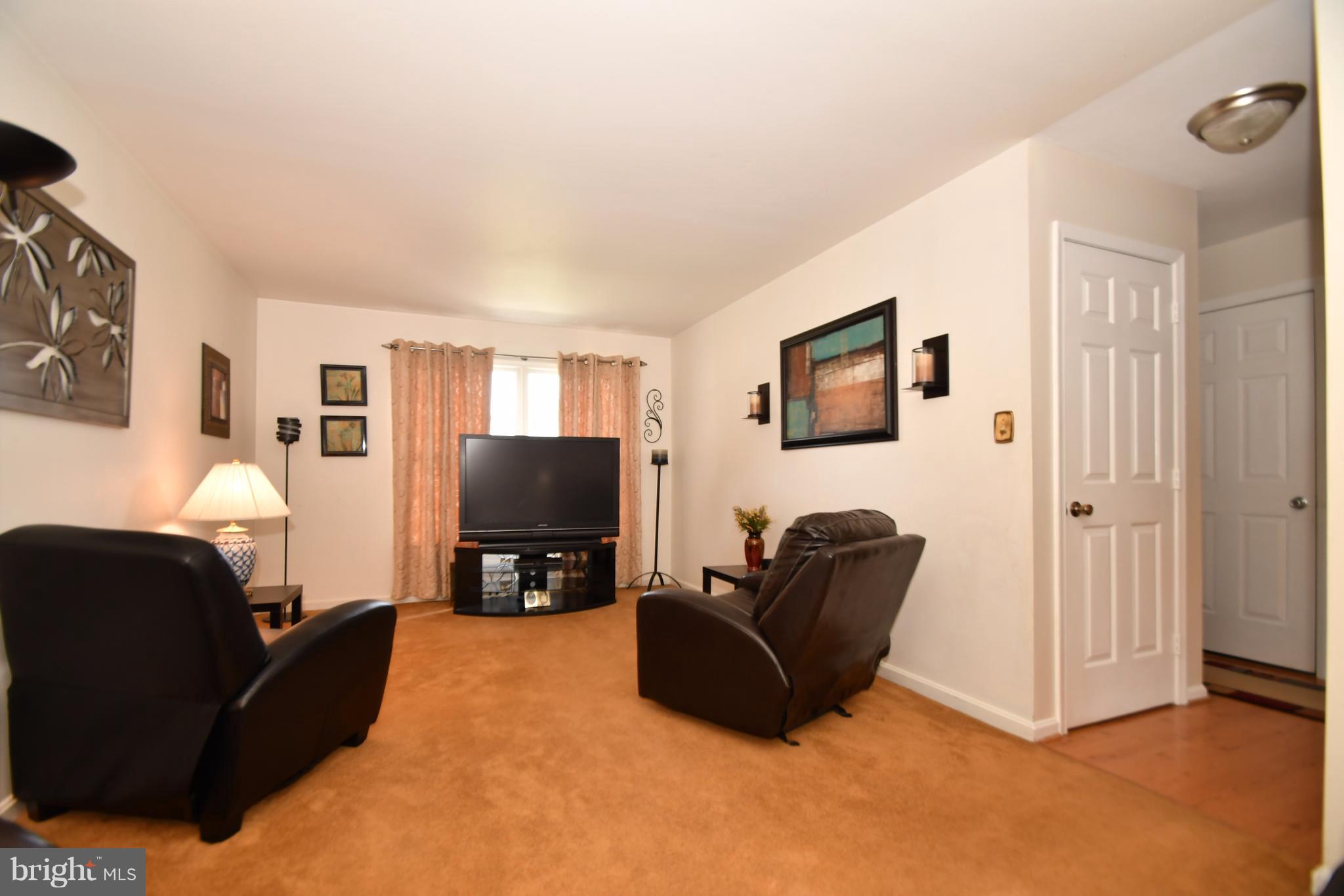 8126 Old Philadelphia Road Baltimore, MD 21237 - Photo 12 of 30 a living room with furniture and a flat screen tv