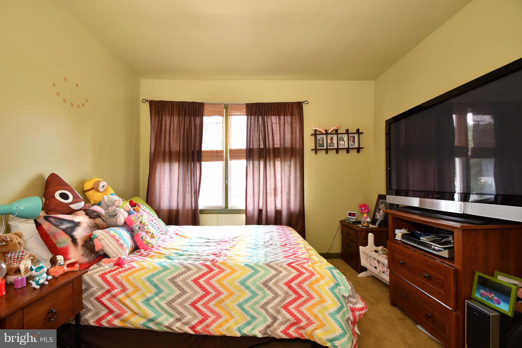 8126 Old Philadelphia Road Baltimore, MD 21237 - Photo 17 of 30 a bedroom with a bed and a flat screen tv