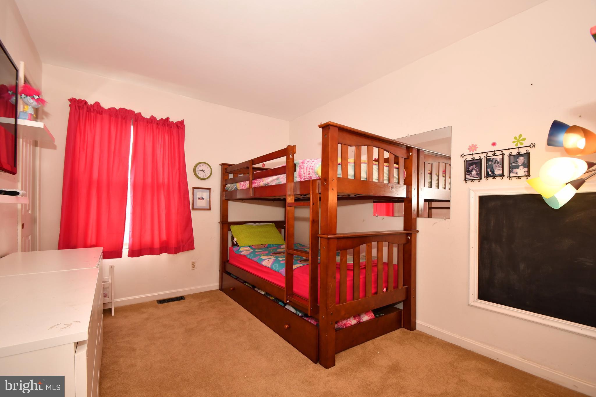 8126 Old Philadelphia Road Baltimore, MD 21237 - Photo 19 of 30 a bedroom with a bed and a baby crib